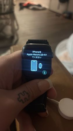 Apple Watch with Black Sport Loop Band and charger