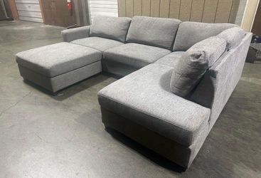 Large gray sectional with matching oversized ottoman