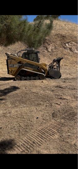 Wood masticator tree mulching skid steer owner operator