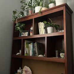 Large dark wood desk with drawers and shelves