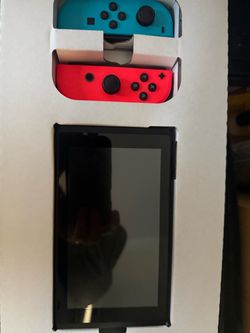 Original Nintendo Switch in box with two games