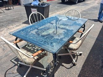 Dinning Room glass top table set with chairs left behind in storage.