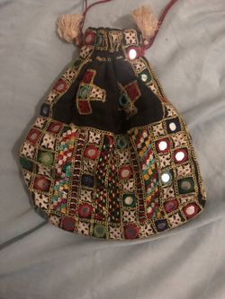 Handcrafted bag with intricate embroidery and mirror details