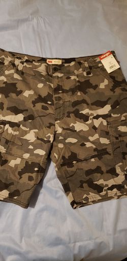 Wrangler brand relaxed fit camo cargo shorts in a green and brown camouflage print with a cargo pocket design