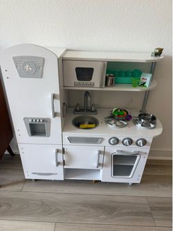 Kids kitchen with some food and staff