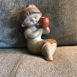 Ceramic Satin Glazed seated Girl holding Pottery