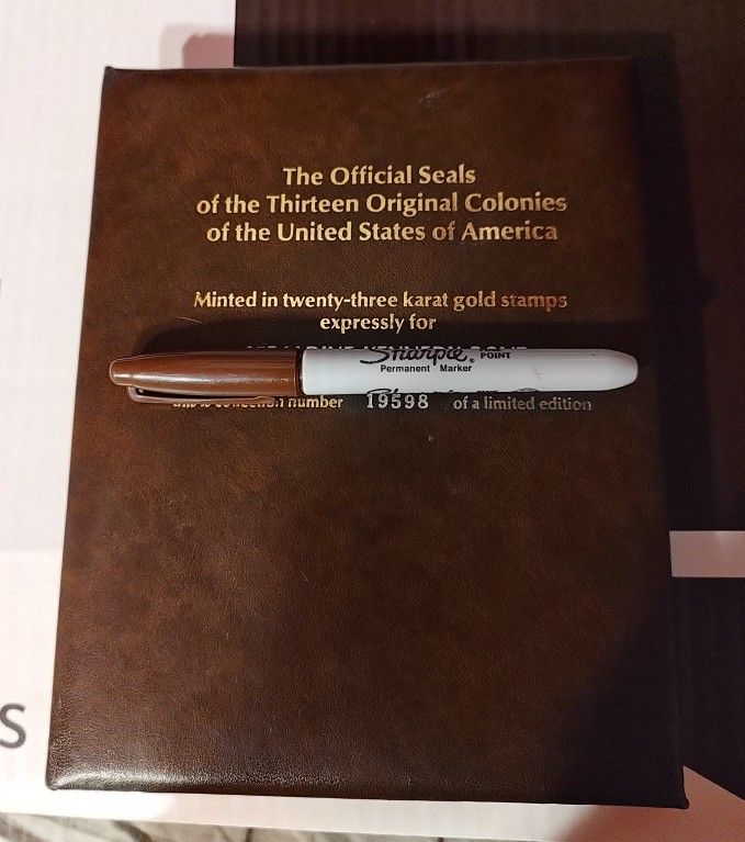 The Official Seals of the Thirteen Original Colonies of the United States of America". The album contains 23-karat gold-plated replicas of the seals,