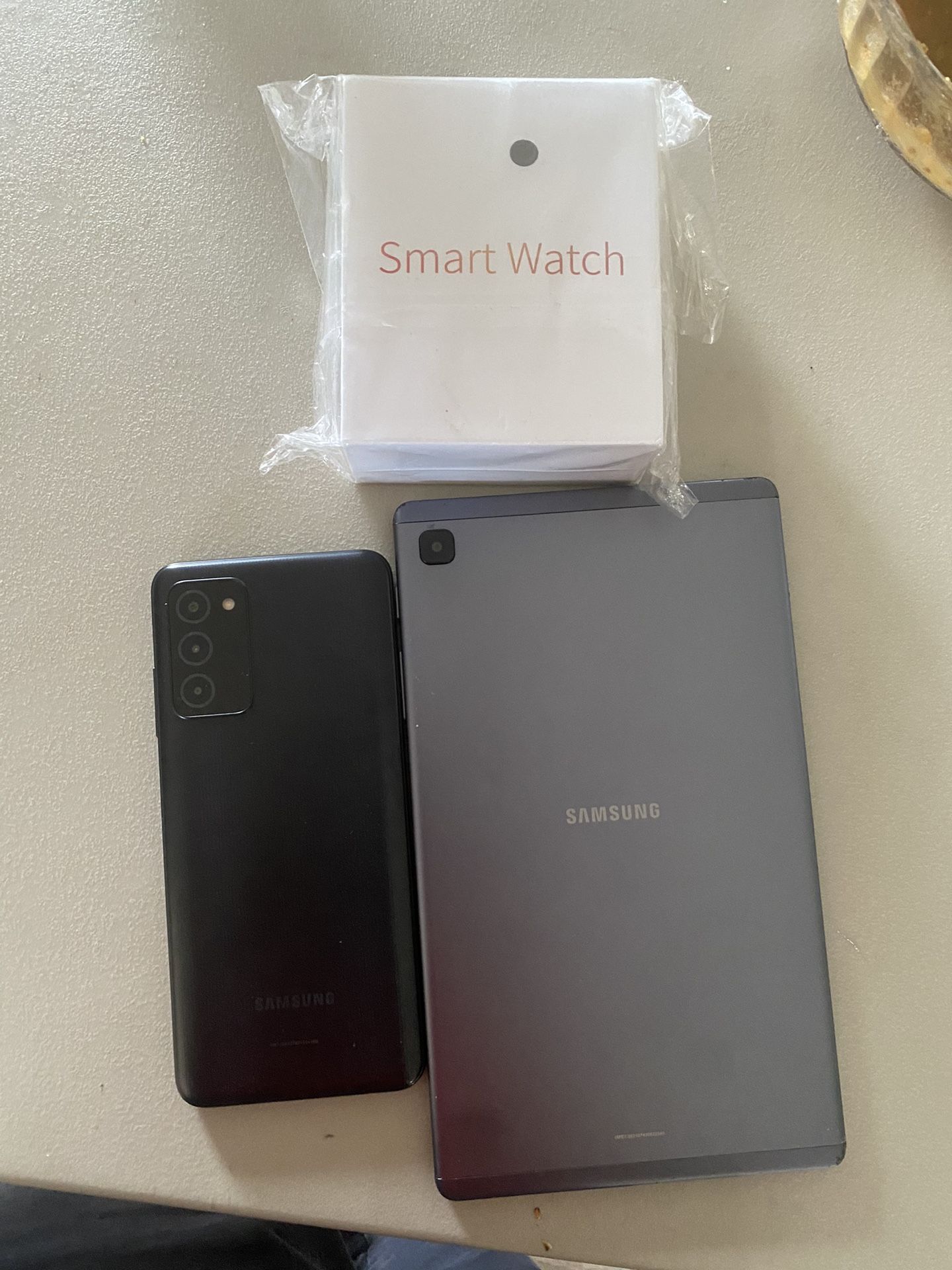 Samsung Tablet And Samsung Phone And A Smart Watch