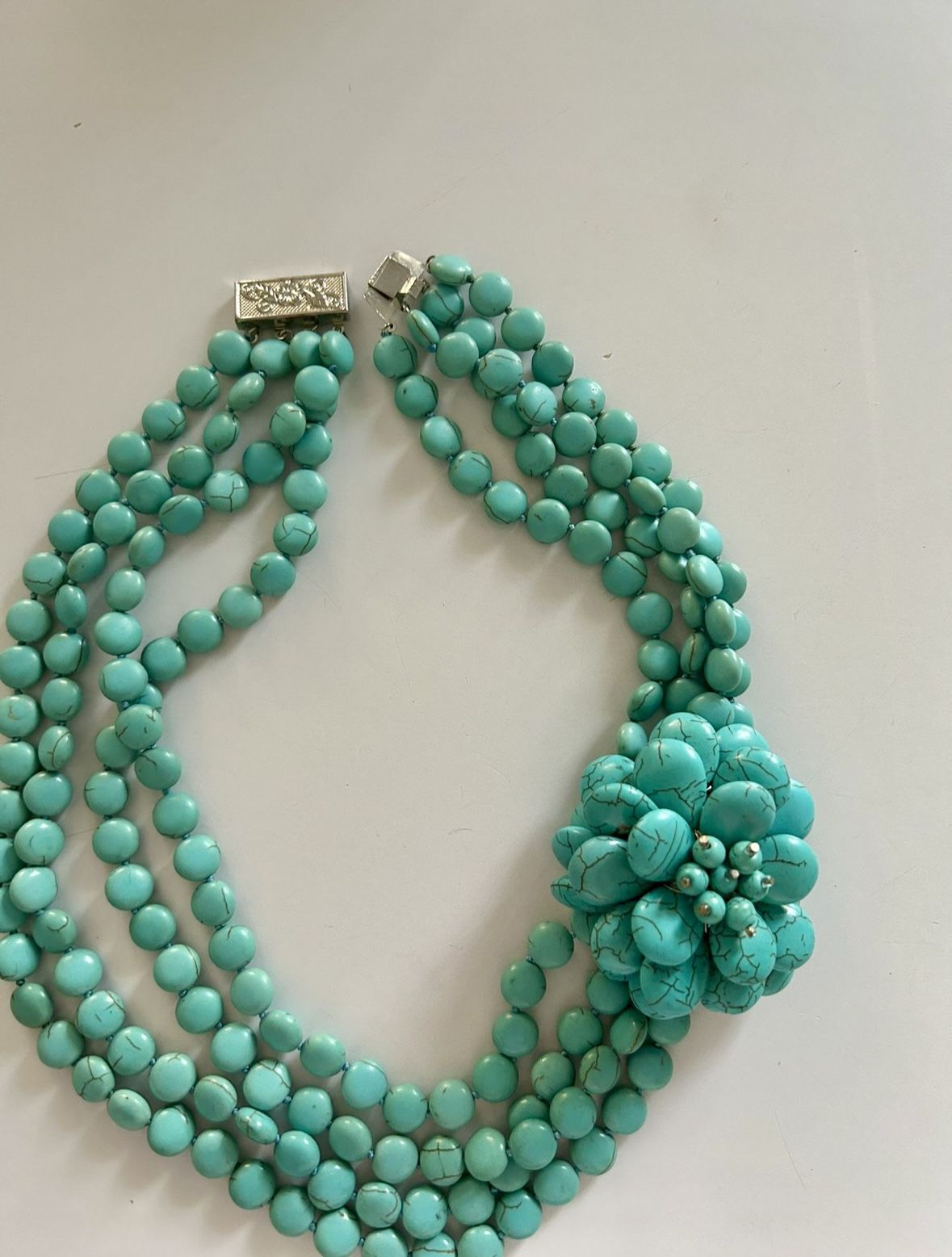 Turquoise Beaded Necklace with Floral Accent and silver clasp.