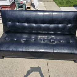 Black leather sofa that folds down and turns into bed. Perfect for office or basement Or Man Cave