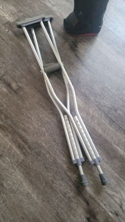 Crutches with a medical walking boot.