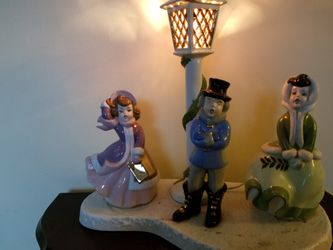 Vintage carol ceramic carolers under a lighted lamppost