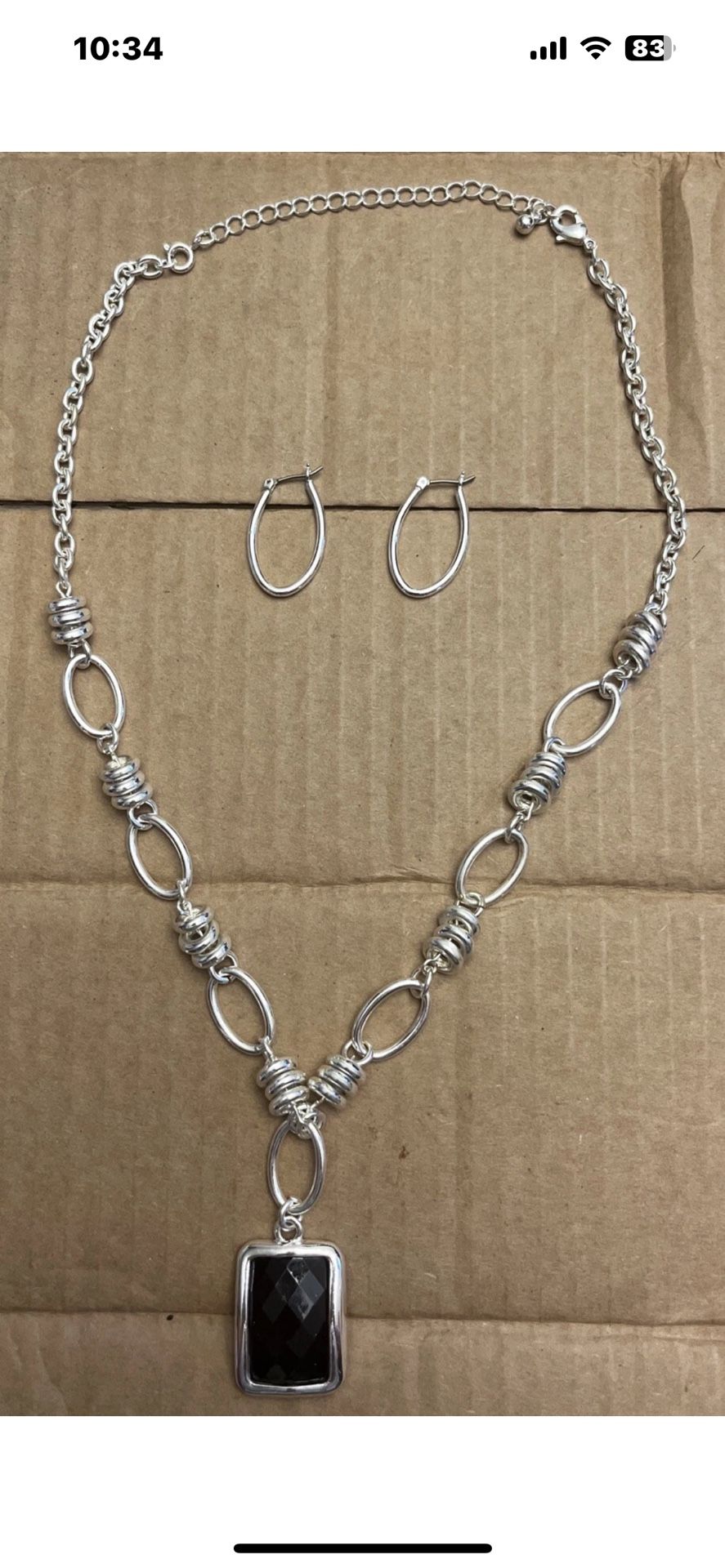 Silver toned Y-drop bubble necklace with matching hoop earrings.