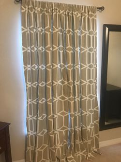 Beige and white patterned black out curtains