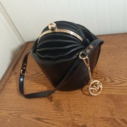 Solid Clutch Bag Comes With A Michael KORS Key Chain . Black and Gold. Very Unique!