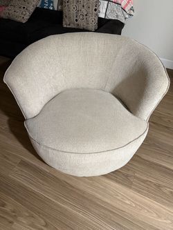 Beige swivel barrel chair