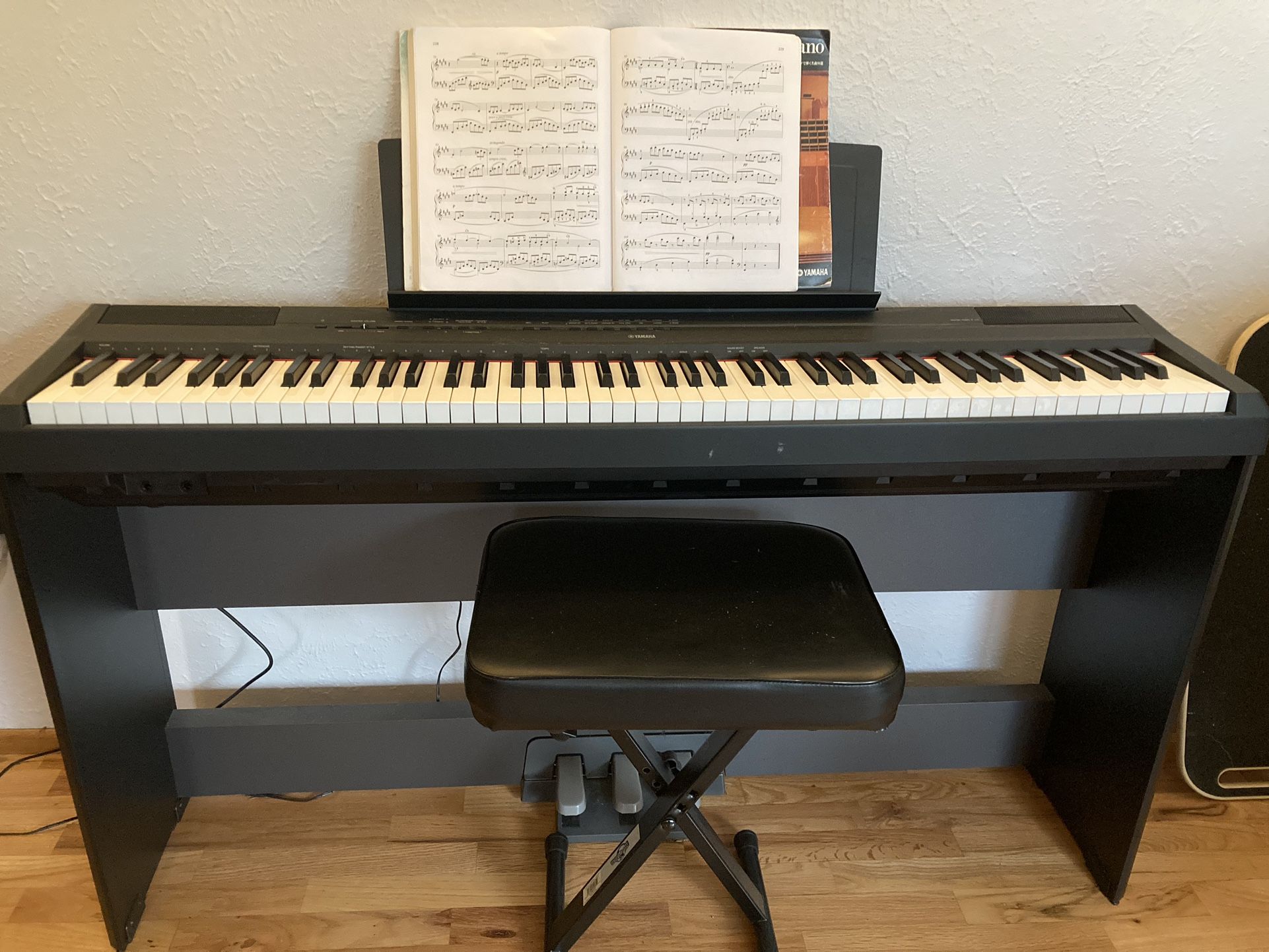 Yamaha P115 digital piano with stand, adjustable bench, and headphones