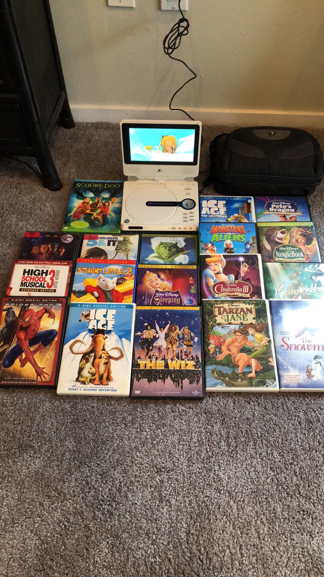 Portable DVD player with 18 kids DVDs Comes with charger/car charger and carrying case