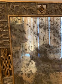 Antique Mirror Gold with Carvings all around.