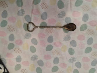 Vintage bar tool, specifically a bottle opener and mixer spoon, from the Hamilton Hotel in St. Louis. 