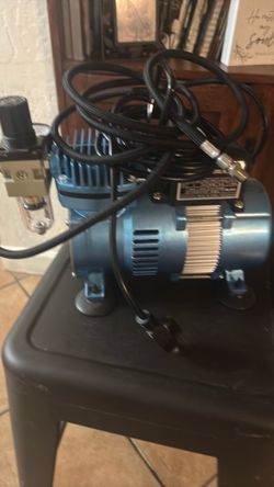 This is a blue Master Airbrush TC-320 Cool Runner II airbrush air compressor