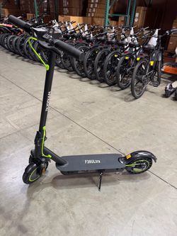 Folding electric scooter with shock absorbers at the front and rear