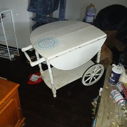 white, drop-leaf wooden tea cart. 