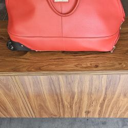 J. M. NEW YORK RED DUFFLR BAG WITH WHEELS AND PULL HANDLE