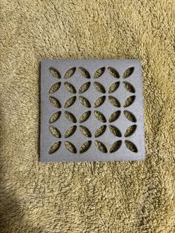  One Schluter Kerdi-Drain 4-inch square grate with a floral pattern