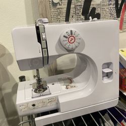 Sewing Machine Contains Needle Extra Thread And Everything Necessary 