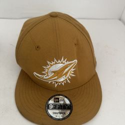 Miami Dolphins New Era 9FIFTY snapback cap in a tan or light brown color.