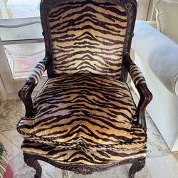 Louis XV-style armchair featuring a carved wooden frame and tiger-print upholstery - Retail: $1295