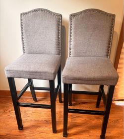 Pair of gray upholstered barstools w/nailhead trim