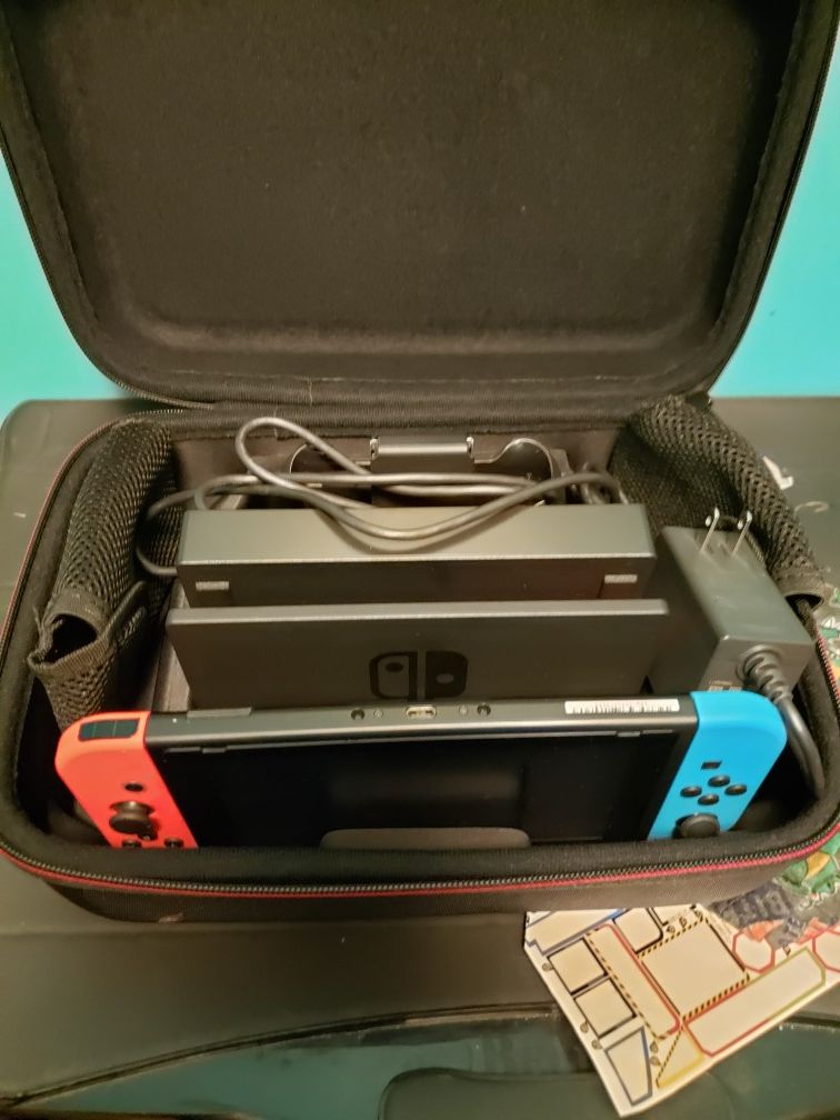 Brand new Nintendo switch V2. Comes with everything in pic. Used a few times. Comes with 2 games as well.