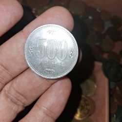Japanese 500 Yen coin minted in 1998. 
Value: 500 Japanese Yen. 
Material: Copper-nickel. 