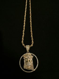 A double plated gold Jesus piece on a 22 inch gold rope chain also double plated