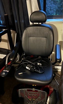 A power wheelchair with the charger to it