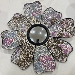 A decorative mosaic floral wall mirror