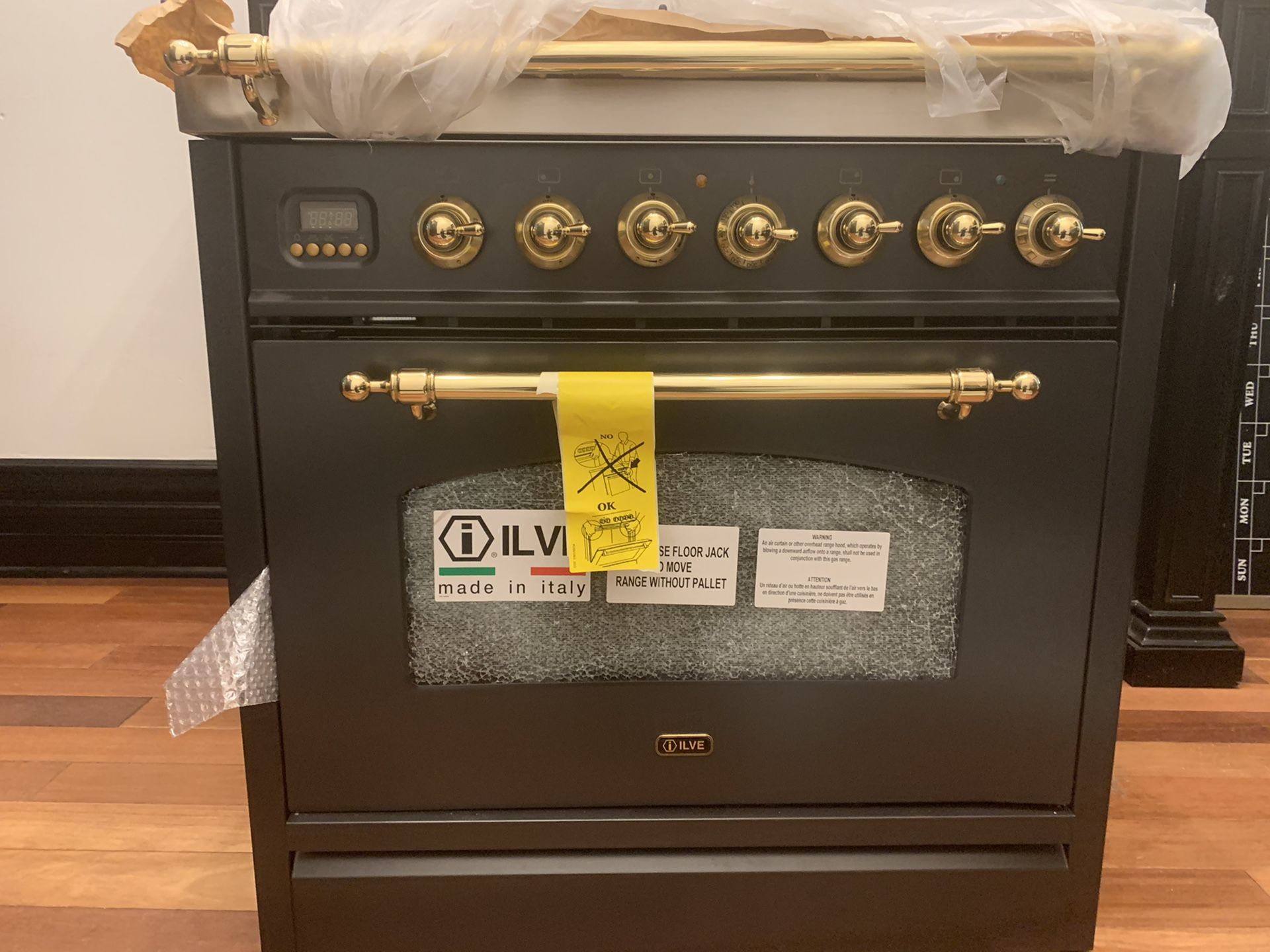 ILVE Nostalgie Series 30" 3 cu.ft. Freestanding Duel Fuel Range in matte graphite/ Brass. Brand new gas cooktop with electric stove (dual fuel).