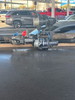 3 fishing poles with reels
