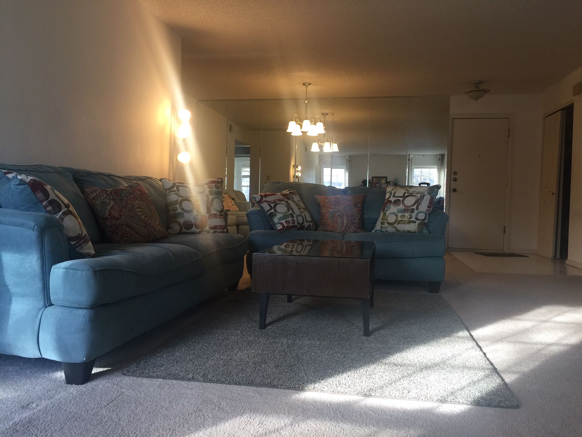 Two sofa, a coffee table, and blue rug.