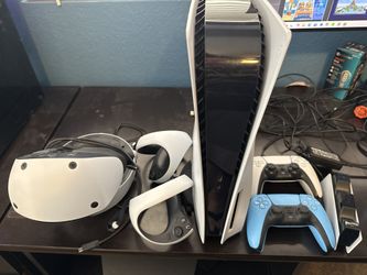 PS5 825GB disc edition, PlayStation VR2, 2 controllers, and charging doc.