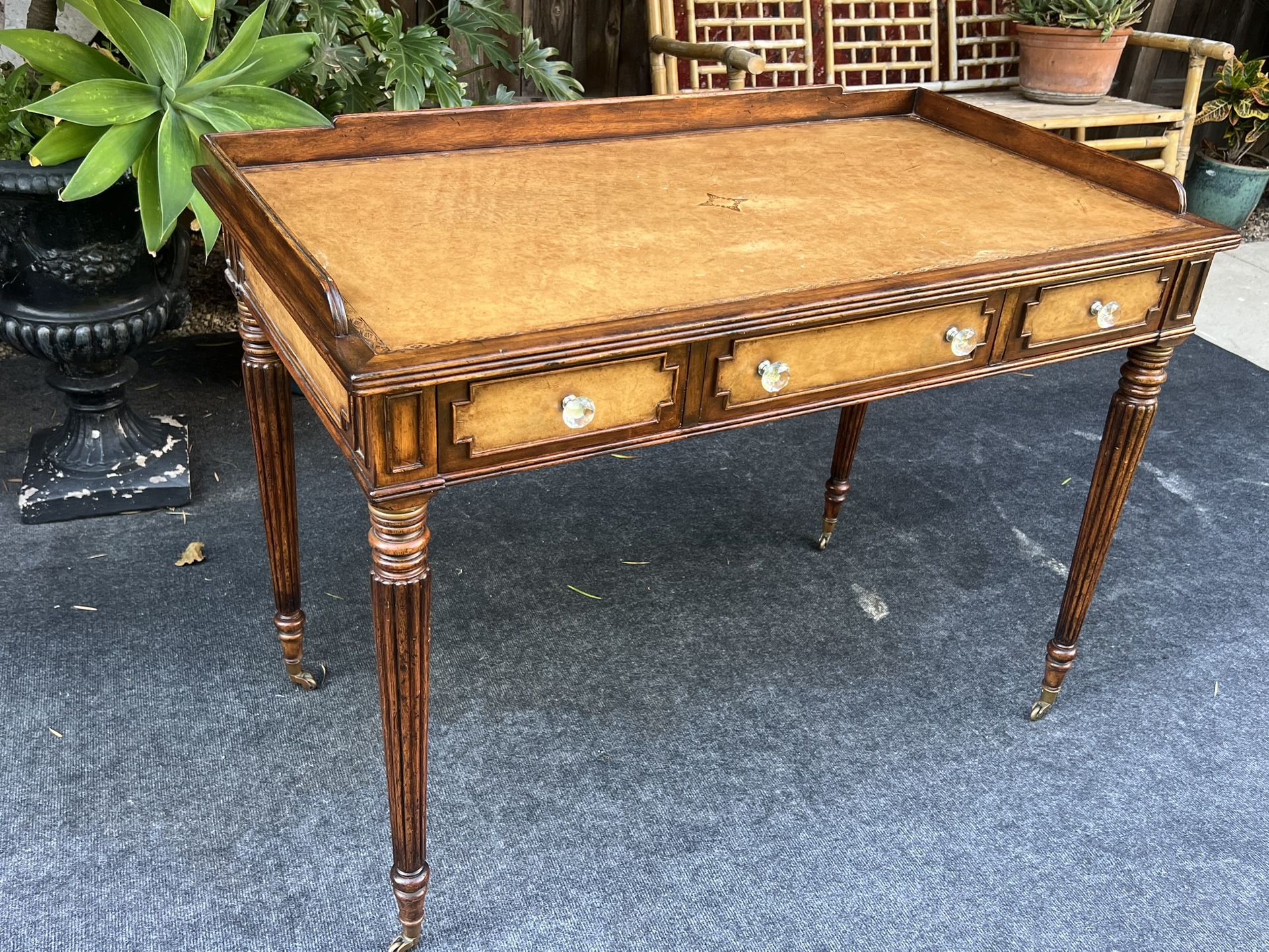 Gorgeous Vintage Writers Desk with Leather Embossed Surface on Casters. 
