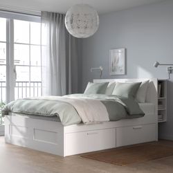 Queen-size white bed frame with storage