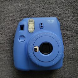 Blue Polaroid camera with accessories