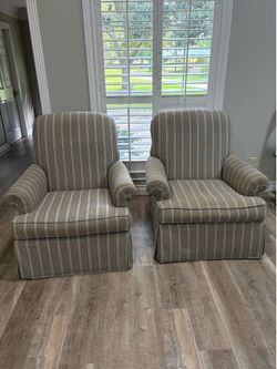 2 gray striped upholstered swivel chairs