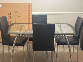 Glass table with 4 chairs fairly used still new like