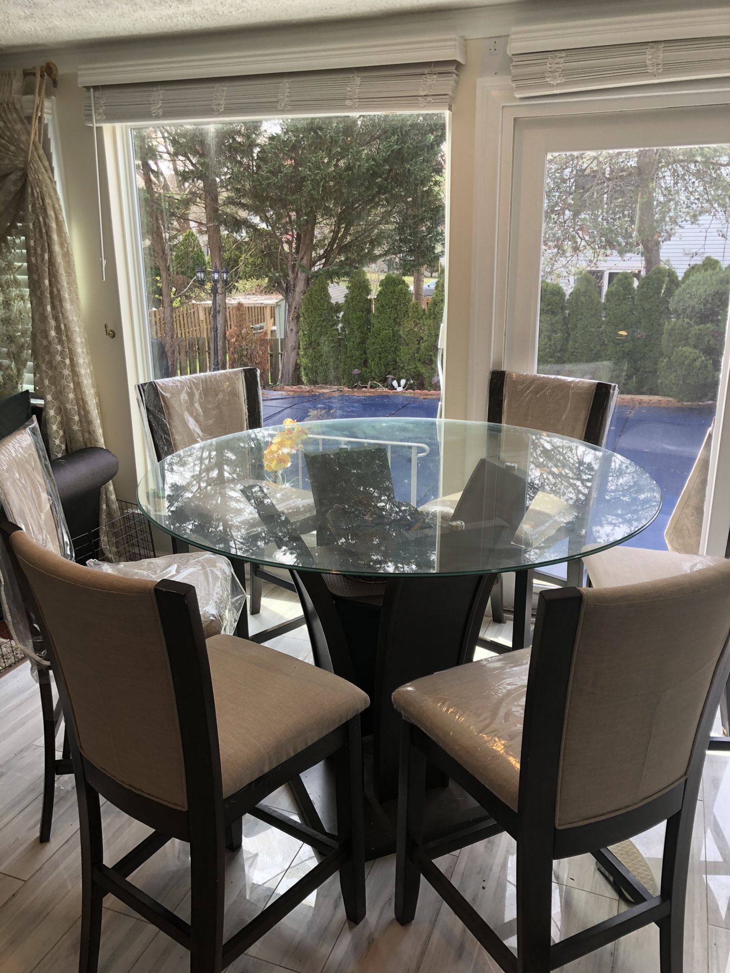 Beautiful dining table, glass top with six chairs. Less than a year old