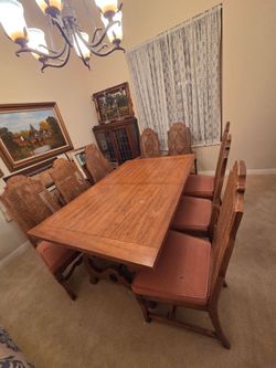 Dining room table seats 14 easily with 8 chairs, 2 extension leaves