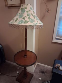 Vintage lamp table.  Table has metal edges. Two light fixtures. A hade included. Needs finial topper to hold shade.